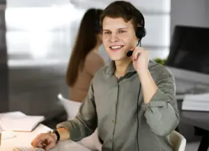 young-dark-haired-guy-green-shirt-headsets-is-talking-modern-office-call-center-operators-work